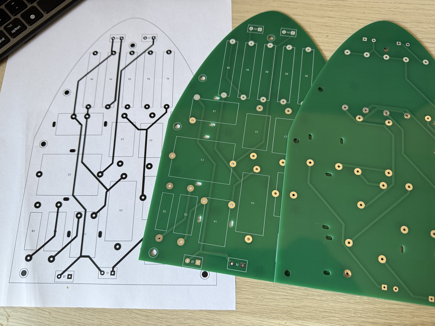 Las placas definitivas, recién llegadas de fábrica. A la izquierda, el trazado impreso a tamaño real que sirve para comprobar con los componentes en la mano que cada huella encaja antes de soldar; al lado, las dos caras de la placa: la de los componentes y la del cobre.